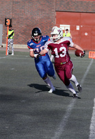 Katri Laine (13) karkaa Trollsin Camilla Hansenilta tekemään ottelun avauspisteet. Laine teki ottelussa lopulta kaksi touchdownia, kahden pisteen lisäpisteen ja merkkautti itselleen myös kaksi pistettä taklaamalla Trolls-pelinrakentajan norjalaisten omalle maalialueelle. Kuva: SAJL